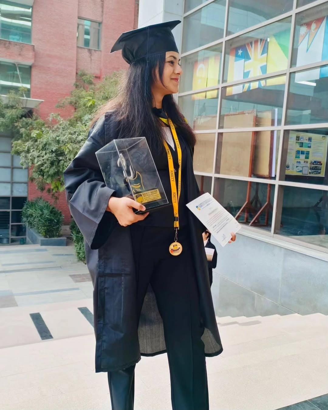 Proudly wearing my gown at my graduation ceremony